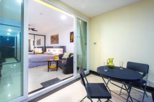 a room with a table and chairs and a bedroom at Beautiful Apartment A6 Central Pattaya in Pattaya