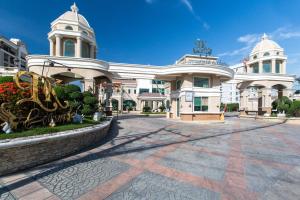 a large white building with two towers at Beautiful Apartment A6 Central Pattaya in Pattaya
