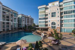 a large swimming pool in front of some buildings at Beautiful Apartment A6 Central Pattaya in Pattaya
