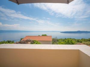 a view of the ocean from the balcony of a house at Holiday house Mavi -Obrs Moscenicka Draga,Riviera Opatija in Mošćenička Draga