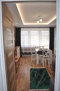 a living room with a table and a dining room at Apartament Sierakowskiego in Sanok