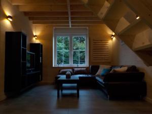 a living room with a couch and a table at Le Chalet in Aywaille