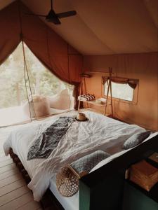 a bedroom with a large bed in a tent at Autentik Penida "Glamping" - Adults only in Nusa Penida