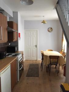 a kitchen and dining room with a table and chairs at Causeway Street Holiday House Self Catering-Portrush in Portrush