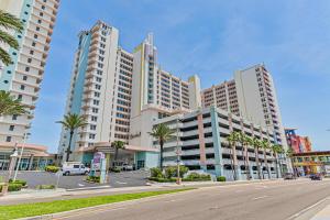 a city street with tall buildings and palm trees at 16th Floor 1 BR Resort Condo Direct Oceanfront Wyndham Ocean Walk Resort Daytona Beach 1605 in Daytona Beach