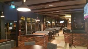 a row of tables and chairs in a restaurant at Corso Apartments B&B in Focşani