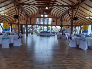 a large banquet hall with white tables and chairs at Domeniul Roa in Avrig +47 photos