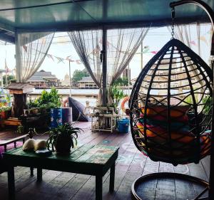 a room with a table and a bird cage at Kunyit 7 Lodge in Bandar Seri Begawan