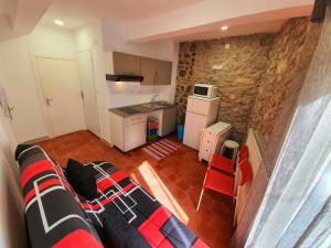 a living room with a couch and a kitchen at APPARTEMENT AGATHOIS-2 in Agde +9 photos