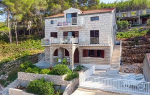 a house on a hill with a staircase leading to it at Apartmani Pipin - Prigradica, kod Caffe Tempera in Prigradica