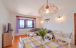 a living room with a table and a couch at Apartmani Pipin - Prigradica, kod Caffe Tempera in Prigradica