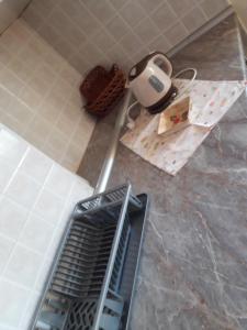 a kitchen with a floor grate in the middle of a kitchen at Apartman LAZAR I VIKTOR in Vrnjačka Banja