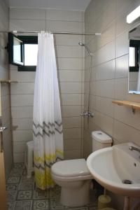 a bathroom with a toilet and a sink at Orange Tree Garden in Pefkochori +27 photos