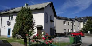 a house with a red car parked in front of it at Appartement Veronika in Öblarn