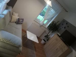 a living room with a white couch and a window at Landhaus Tirol in Presseggersee