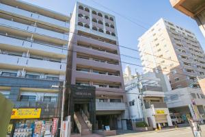 an apartment building on a city street at Sumiyoshi Apartment in Fukuoka