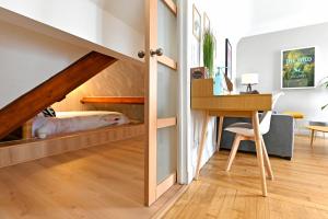 ein Schlafzimmer mit einem Etagenbett und einem Schreibtisch in einem Zimmer in der Unterkunft HYPERCENTRE - Calme et lumineux. AufildeLorient in Lorient