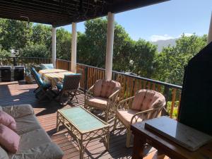 a deck with chairs and a table and a tableablish at Apartment Downstairs Sedgefield in Sedgefield