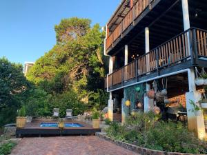 a building with a patio and a deck with a patioitures at Apartment Downstairs Sedgefield in Sedgefield