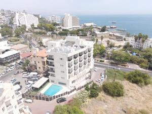 an aerial view of a building and the ocean at Emily's Hotel in Tiberias