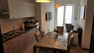 a kitchen with a table with chairs and a counter top at Apartment Atlantic Roseto Beach in Roseto degli Abruzzi