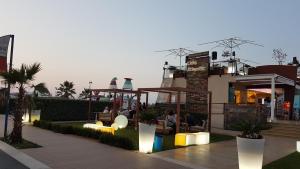 a group of people sitting on a balcony of a building at Apartment Atlantic Roseto Beach in Roseto degli Abruzzi +5 photos