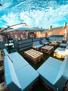 a patio with tables and chairs and an umbrella at The Red Lion Inn in Rothwell