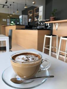 a cup of coffee on a table with a spoon at Villa White in Ksamil