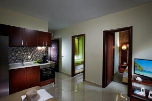 a kitchen with wooden cabinets and a tv in it at 4- you Family in Metamorfosi