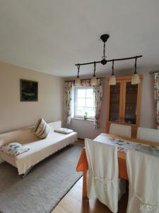 a bedroom with a bed and a table and chairs at Öko-Ferienhaus in Rappin