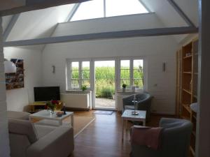 a living room with a skylight and a couch and a table at Schlei-Rose in Schaalby