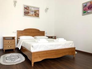a bedroom with a bed with two towels on it at Apartment Provence in Uzhhorod