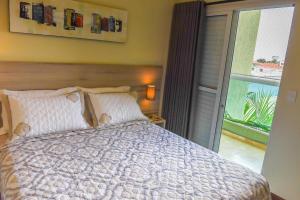 A bed or beds in a room at Residencial Flat Villa Rosa
