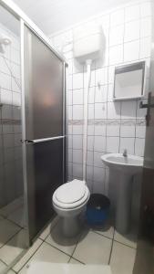 a bathroom with a toilet and a sink at Hotel Praia Grande in Penha +36 photos