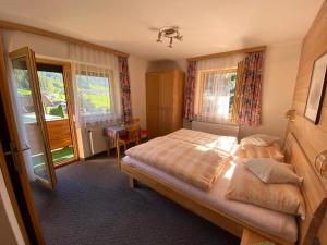 a bedroom with a bed and a large window at Haus Wildspitz in Neustift im Stubaital