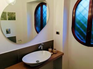 a bathroom with a sink and two large windows at Relais Casa Moresca in Terracina +49 photos