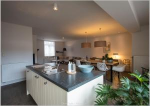 a kitchen and living room with a counter top at murkerka in Damme