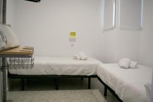 Cama o camas de una habitación en Alojamientos Teatro