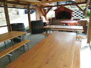 a group of wooden tables in a building with barrels at Robinzonski smještaj Tepeš in Tuheljske Toplice