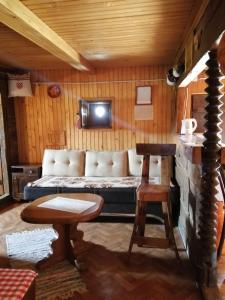 a living room with a couch and a table at Robinzonski smještaj Tepeš in Tuheljske Toplice