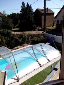 a swimming pool in a yard with a cover at LE JR 70 Relais Motards in Magny-dʼAnigon