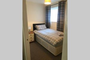 a small bedroom with a bed and a window at Newton Aycliffe Contractors Accommodation in Newton Aycliffe