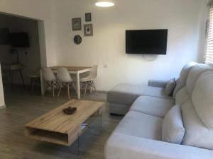a living room with a couch and a table at Maxorata City Center Fuerteventura in Morro del Jable