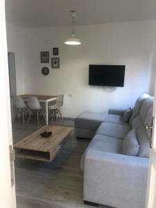 a living room with a couch and a table at Maxorata City Center Fuerteventura in Morro del Jable