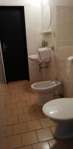 a bathroom with a white toilet and a sink at Hotel Apollo in Valašské Meziříčí