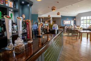 a bar in a pub with people sitting in the background at The Boat House in Kilsyth +36 photos