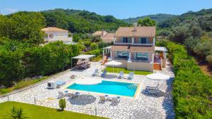 an aerial view of a house with a swimming pool at Avlaki Beachfront Villa in Kassiopi