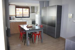 
a kitchen with a refrigerator and a table at Camalavi in Moraira
