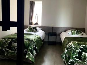 Un pat sau paturi într-o cameră la Gastenverblijf ‘t Landsheertje