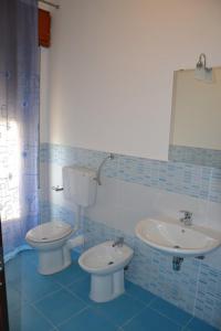 a bathroom with a toilet and a sink at A Due Passi da Erice B&B in Erice